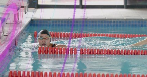 Determined female swimmer training in pool swim lane