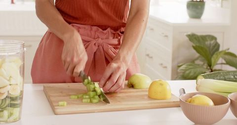 Woman Preparing Fresh Ingredients in Bright Modern Kitchen