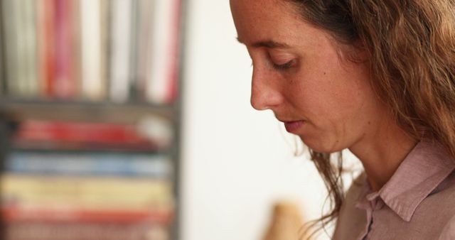 Thoughtful Woman Reading in Home Library - Download Free Stock Images Pikwizard.com