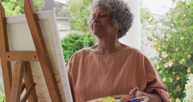 Senior African American Woman Painting on Easel Outdoors - Download Free Stock Images Pikwizard.com