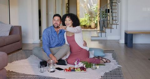 Diverse Couple Enjoying Romantic Indoor Picnic