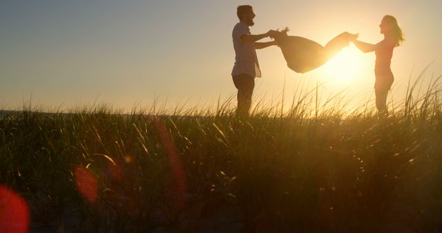 Couple enjoying sunset at beach with baby - Download Free Stock Images Pikwizard.com