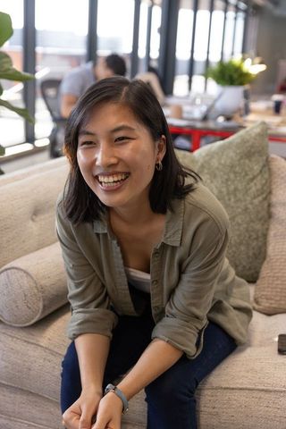 Young Professional Laughing in Modern Office Lounge