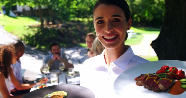 Friendly Waitress Serving Gourmet Meals at Outdoor Restaurant - Download Free Stock Images Pikwizard.com