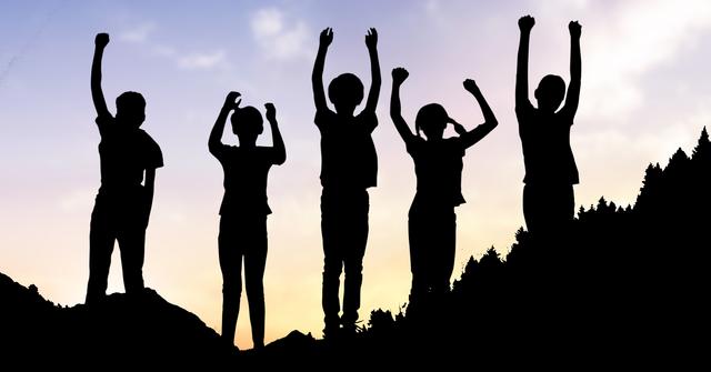 Digital composite of Silhouette children with arms raised standing on hill