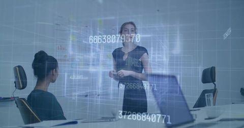 Female presenter leading futuristic data visualization in boardroom with holographic displays