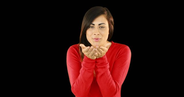 Woman in Red Sweater Blowing a Kiss Against Black Background - Download Free Stock Images Pikwizard.com