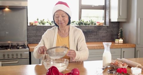 Senior Woman Wearing Santa Hat Preparing Holiday Dough