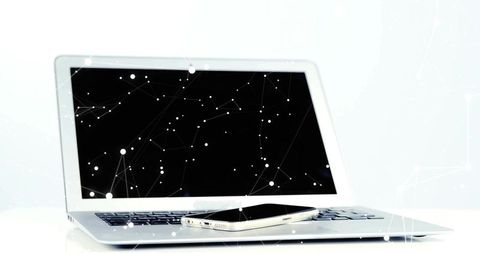 Minimalist Laptop and Smartphone with Digital Network Overlay for Modern Tech