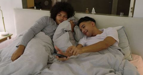 Couple Relaxing in Cozy Bedroom, Sharing Intimate Snapshot