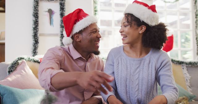 Portrait of happy african american couple with santa hats having image call - Download Free Stock Photos Pikwizard.com