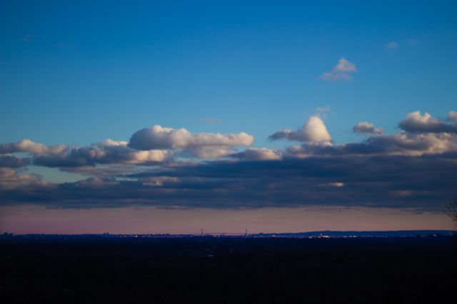 Scenic blue sky with layered clouds at sunset - Download Free Stock Photos Pikwizard.com