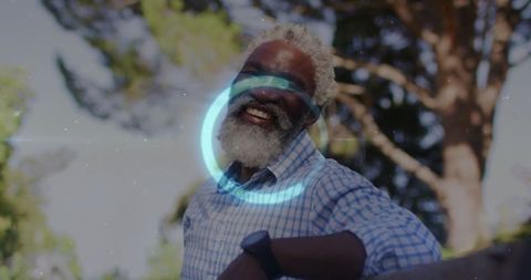 Senior Man Smiling in Sunlit Garden Leaning on Railing