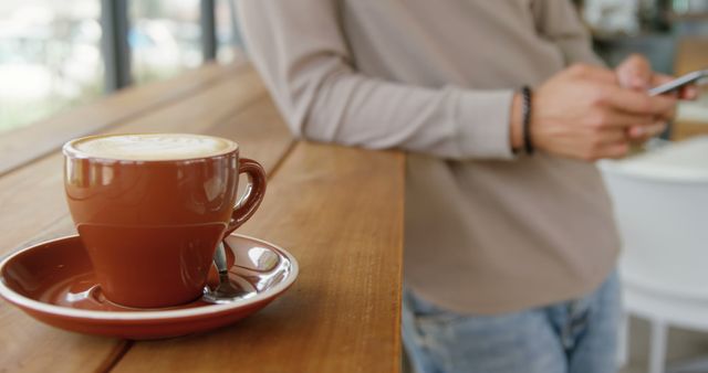 Person Enjoying Coffee While Using Smartphone in Cafe - Download Free Stock Images Pikwizard.com