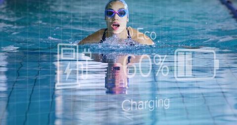 Competitive swimmer breaking surface in indoor lap pool with augmented hud overlay