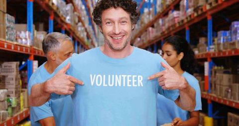 Optimistic volunteer in warehouse smiling and promoting community service