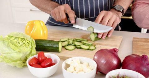 Couple Slicing Fresh Vegetables in Modern Home Kitchen