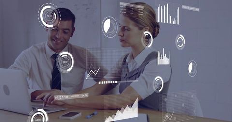 Business professionals reviewing AR data visualization and analytics on laptop at meeting table
