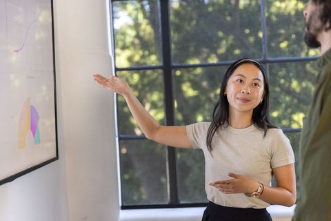 Diverse Team Analyzing Business Charts in Office Meeting
