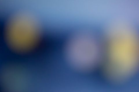 Abstract blur of out-of-focus objects on blue background