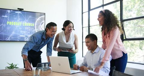 Diverse Team Celebrates Successful Product Launch in Office