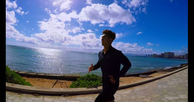 Man Jogging Along Coastal Path Under Blue Sky - Download Free Stock Images Pikwizard.com