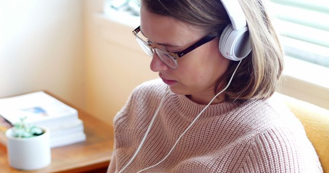 Woman Wearing Headphones and Glasses While Reading - Download Free Stock Images Pikwizard.com