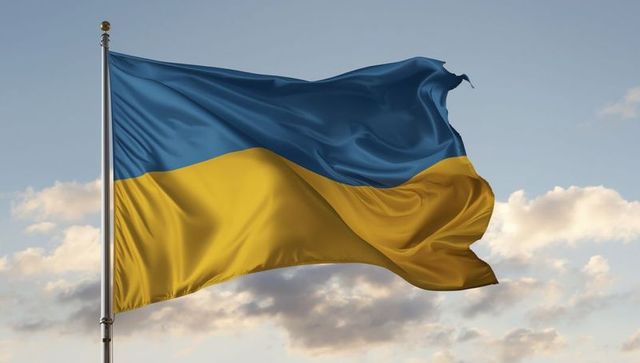 Ukrainian flag flutters against calm sky