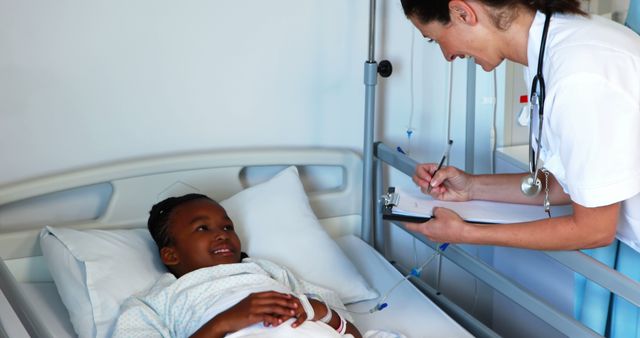 Doctor checking on young patient in hospital room - Download Free Stock Images Pikwizard.com