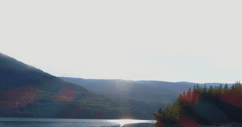 transparent sunrise over serene river with mountain backdrop - Download Free Stock Videos Pikwizard.com