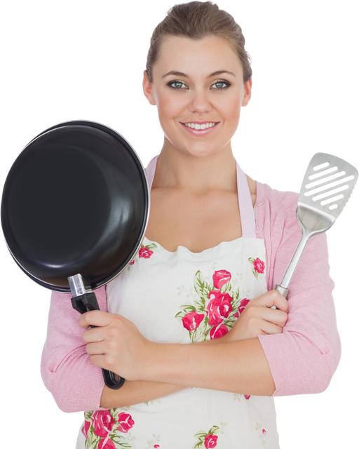 Smiling Woman Holding Frying Pan and Spatula in Floral Apron - Download Free Stock Videos Pikwizard.com