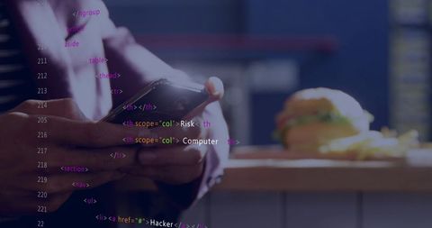 Man holding and tapping smartphone at cafe counter with burger and code overlay