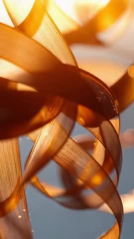 Shifting amber ribbons backlit by sunrise, translucent macro vertical motion