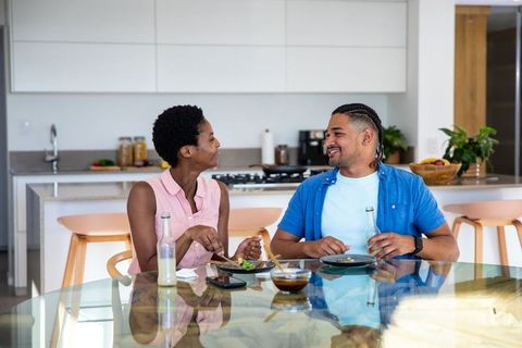 Smiling Couple Enjoys Lunch Together in Modern Kitchen Setting