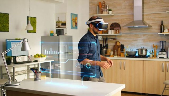 Man wearing vr headset interacting with holographic data charts over modern kitchen island
