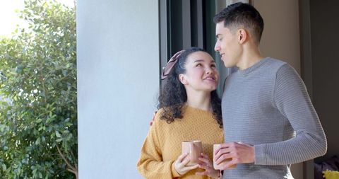 Romantic Couple Enjoying Coffee by Sliding Glass Door