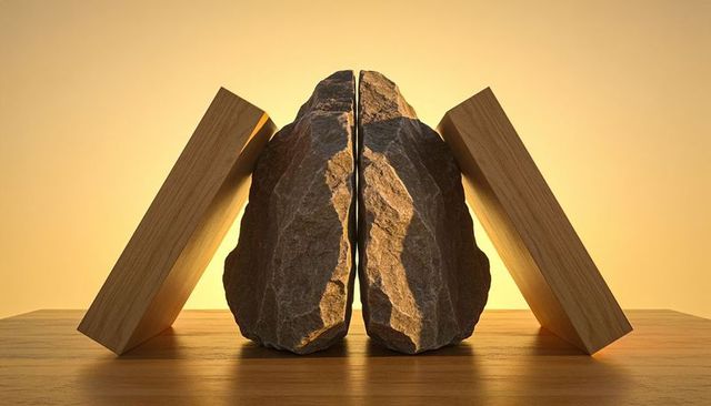 Split rough rock halves as rustic bookends with wooden blocks and warm golden backlight