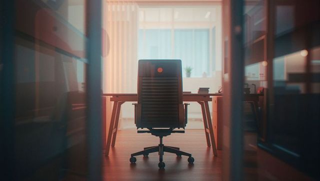 Modern office workspace with ergonomic swivel chair and desk