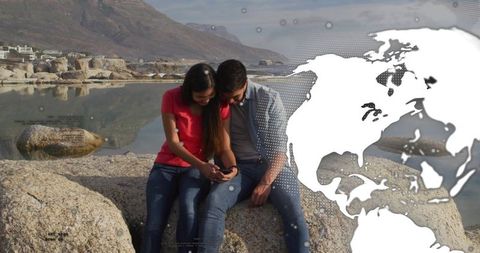 Couple Enjoying Scenic Lake View with Digital Globe Overlay