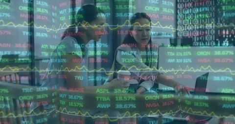 Professionals Analyzing Stock Market Data at Cafe