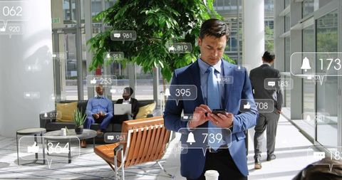 Businessman checking smartphone in modern glass atrium with floating social notifications