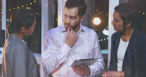 Business Professionals Analyzing Data on Tablet in Office