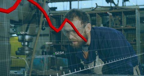 Machinist inspecting milling machine with data overlay and downward red chart