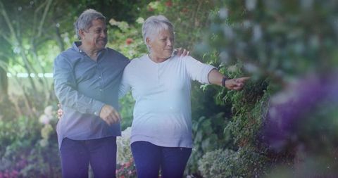 Senior Couple Enjoying Peaceful Walk in Lush Garden