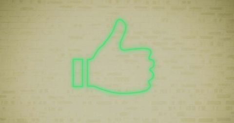 Neon green thumbs up sign against brick wall background