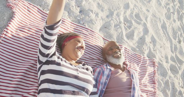 Happy Senior Couple Relaxing Together on Beach Blanket in Sunlight - Download Free Stock Images Pikwizard.com