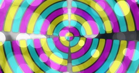 Concentric Neon Target Showing Cyan Magenta Yellow Segmented Rings with Bokeh Glow