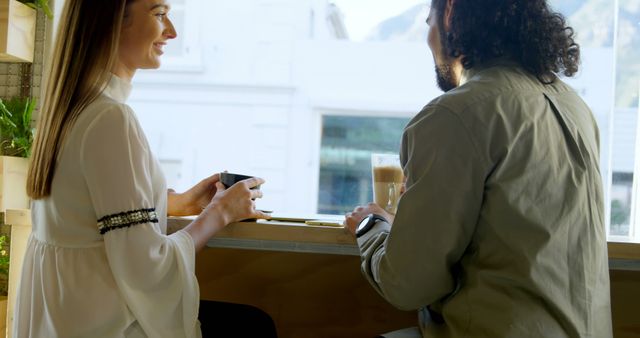 Two Friends Enjoying Coffee in Modern Café - Download Free Stock Images Pikwizard.com