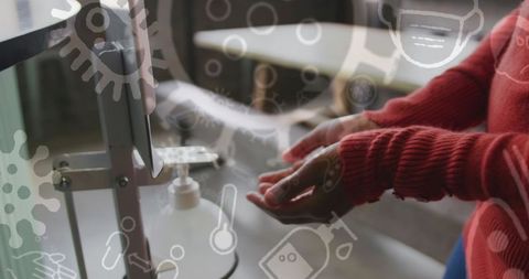 Person using hand sanitizer with covid-19 icons overlay