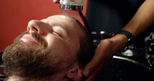 Bearded Man Enjoying Relaxing Hair Wash at Salon - Download Free Stock Images Pikwizard.com